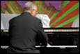 A person playing a piano

Description automatically generated with medium confidence