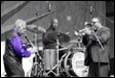 A group of people playing instruments

Description automatically generated with medium confidence