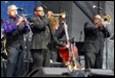 A group of people playing instruments

Description automatically generated with medium confidence