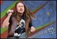 A person with long hair and a guitar

Description automatically generated with low confidence