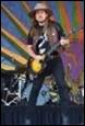 A person playing a guitar on a stage

Description automatically generated with medium confidence