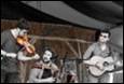 A group of people playing instruments

Description automatically generated