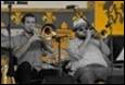 A group of people playing instruments

Description automatically generated with medium confidence