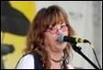 A person singing into a microphone

Description automatically generated