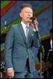 A person in a suit speaking into a microphone

Description automatically generated with medium confidence