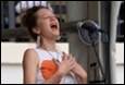A person singing into a microphone

Description automatically generated with medium confidence