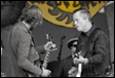 A group of men playing guitars

Description automatically generated with medium confidence