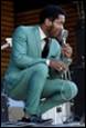 A person in a suit holding a microphone

Description automatically generated with medium confidence