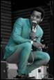 A person in a blue suit holding a microphone

Description automatically generated with medium confidence