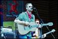 A person playing guitar on stage

Description automatically generated with low confidence