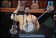A person playing a banjo

Description automatically generated
