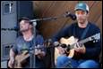 A group of men playing guitars

Description automatically generated
