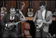 A group of men playing instruments

Description automatically generated
