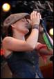 A person singing into a microphone

Description automatically generated