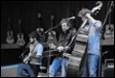A group of people playing instruments

Description automatically generated