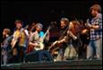 A group of people playing instruments

Description automatically generated