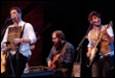 A group of men playing instruments

Description automatically generated