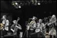 A group of people playing instruments

Description automatically generated