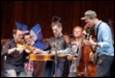 A group of people playing instruments

Description automatically generated