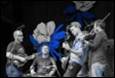A group of people playing instruments

Description automatically generated