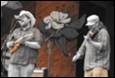 A couple of men playing instruments

Description automatically generated