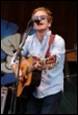 A person playing a guitar

Description automatically generated