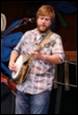 A person playing a banjo

Description automatically generated