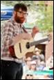 A person playing a guitar

Description automatically generated