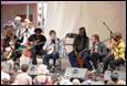 A group of people playing instruments

Description automatically generated
