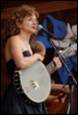 A person playing a banjo

Description automatically generated