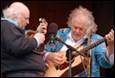 A person playing guitar and another person playing guitar

Description automatically generated