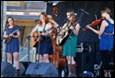 A group of women playing instruments

Description automatically generated