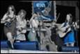A group of people playing instruments

Description automatically generated