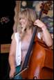 A person holding a cello

Description automatically generated