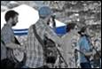 A group of people standing outside

Description automatically generated