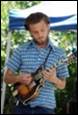 A person playing a guitar

Description automatically generated