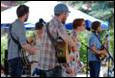 A group of people with guitars

Description automatically generated