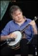A person playing a banjo

Description automatically generated