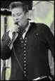 A person singing into a microphone

Description automatically generated