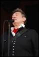A person singing into a microphone

Description automatically generated