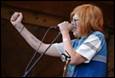 A person singing into a microphone

Description automatically generated