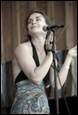A person singing into a microphone

Description automatically generated