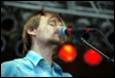 A person singing into a microphone

Description automatically generated