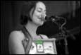A person singing into a microphone

Description automatically generated