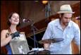 A person and person playing drums

Description automatically generated