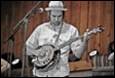 A person playing a banjo

Description automatically generated