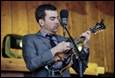 A person playing a guitar

Description automatically generated