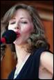 A person singing into a microphone

Description automatically generated