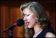A person singing into a microphone

Description automatically generated