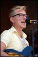 A person singing into a microphone

Description automatically generated